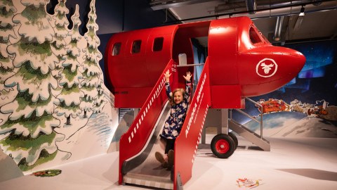  A child enjoying themselves at the Santa Clause's Airplane's slide.