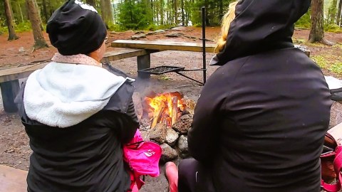 Women sitting by campfire