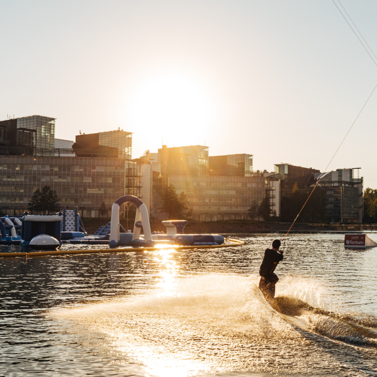 Person wakeboarding during golden hour in Keilaniemi area