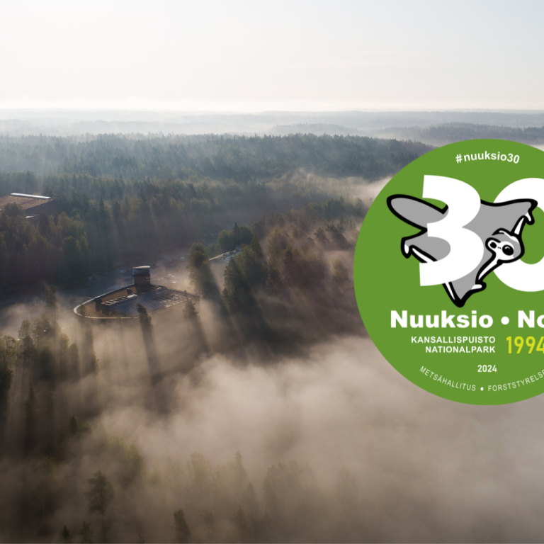 Dron view over Nuuksio National park and Finnish Nature Centre Haltia in for and Nuuksio 30 years old logo
