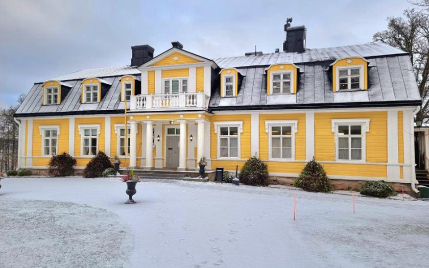 Yellow colored Manor during winter