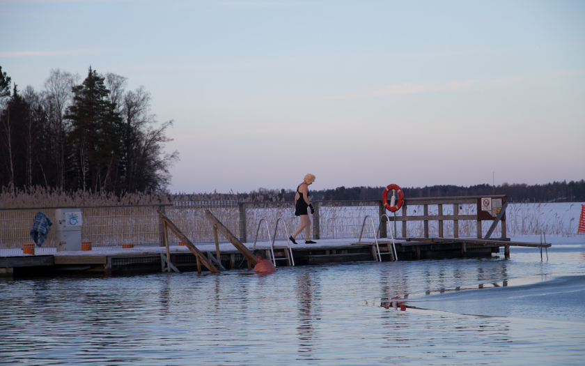Person walking on the deck to the winter swimming area