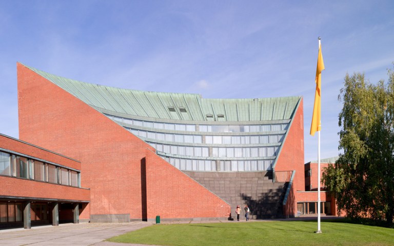 The fan-shaped reb brick building of Aalto University's Undergraduate Centre.
