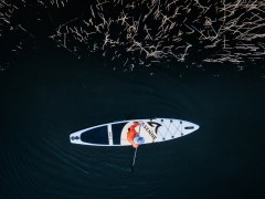 Dron view of a person SUPboarding