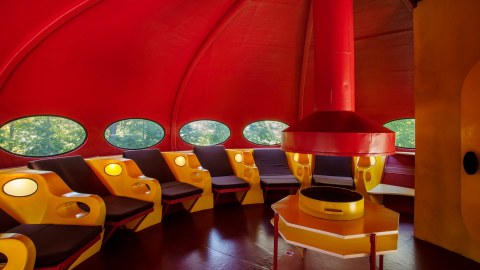 The Futuro House interior with the seat-beds and the fireplace-grill-table combination.