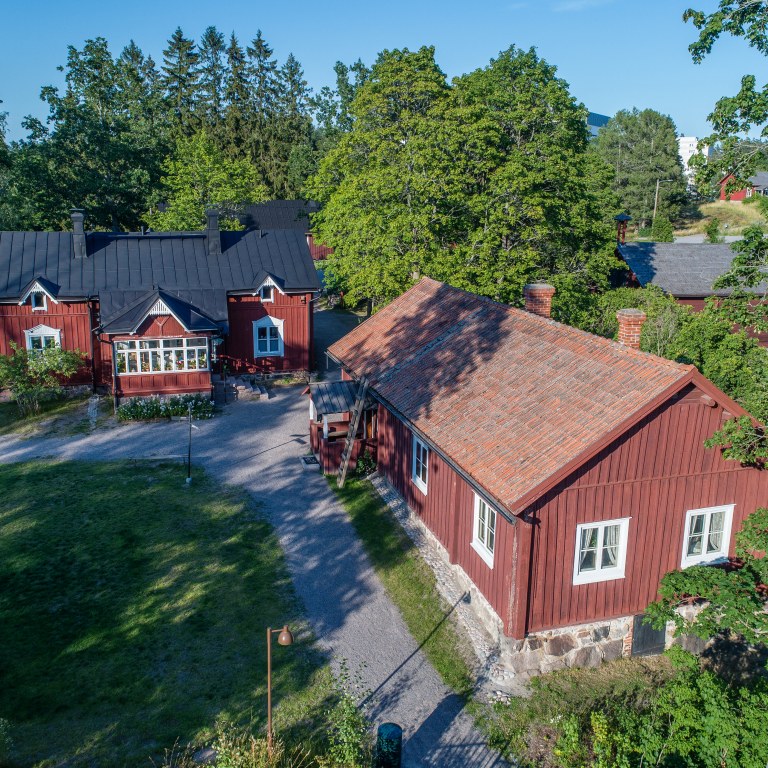 The red buildings of the Farmstead Museum Glims photographed from the air in summer.