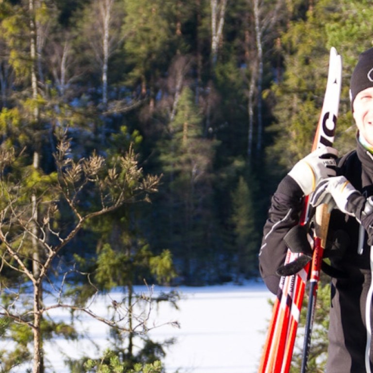 Couple cross-country skiing in forest