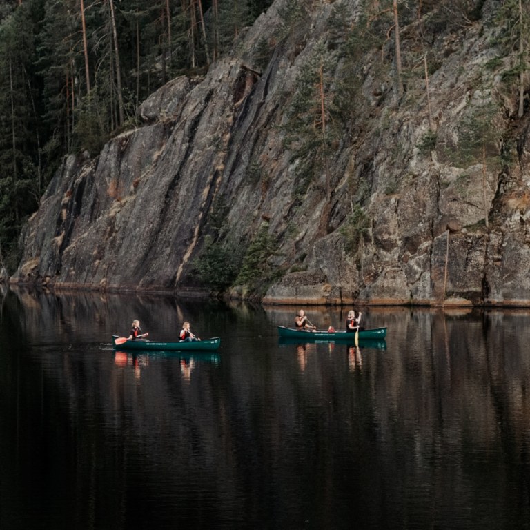 Group canoeing on lake in Nuuksio National Park