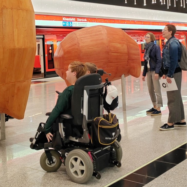 Couple of wheelchair tourist during metro guided tour