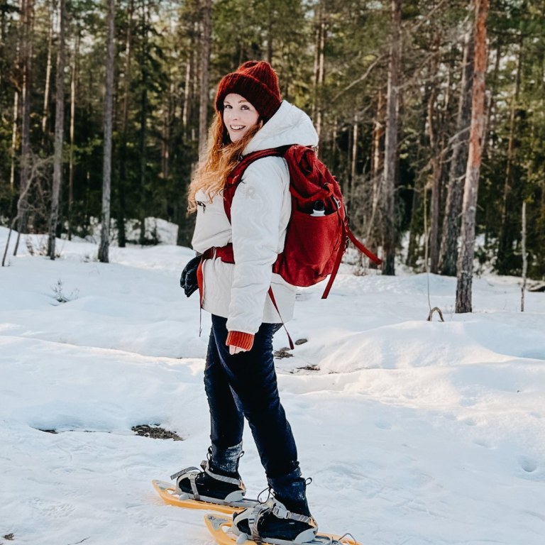 Woman walking in snowshoes in forest