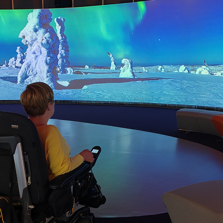 Wheelchair visitor exploring Finnish Nature Centre Haltia indoor's exhibition