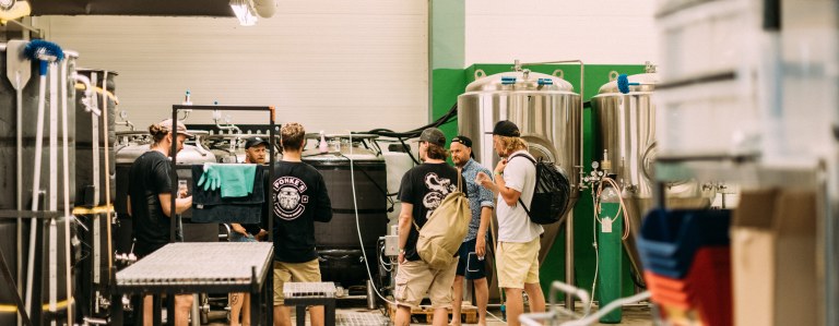 A group of people on a guided tour on local brewery.