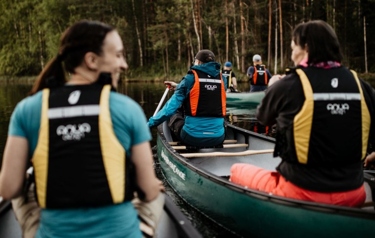 A group canoeing in the Nuuksio National Park