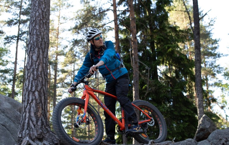 A man riding a fatbike in the forest