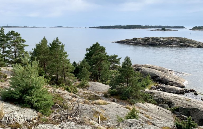 The scene from the Cape of Porkkala peninsula showcases small islands and a lighthouse. 