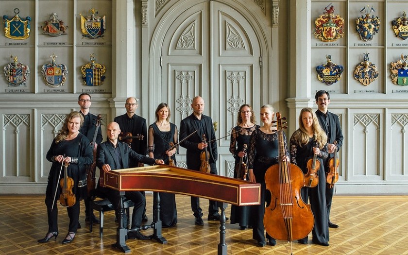 Group of classical musicians inside historical building