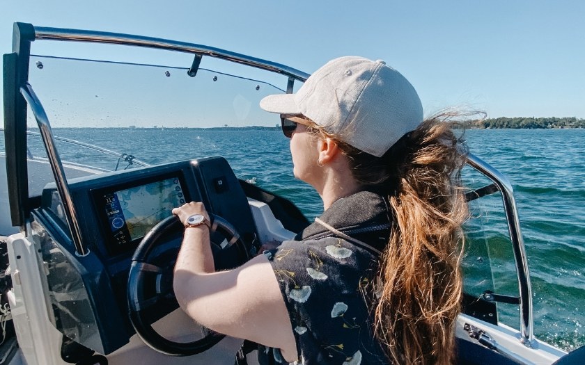 Woman driving a boat in Baltic Sea