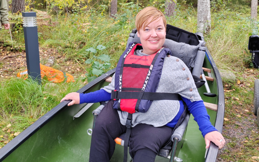 Woman with disabilities inside canoe 