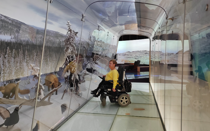 Wheelchair visitor exploring indoors exhibitions at Finnish Nature Centre Haltia 