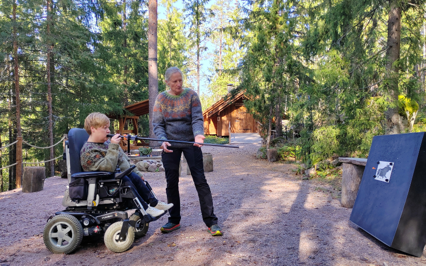 Wheelchair visitor testing one of program services at Nuuksion Taika