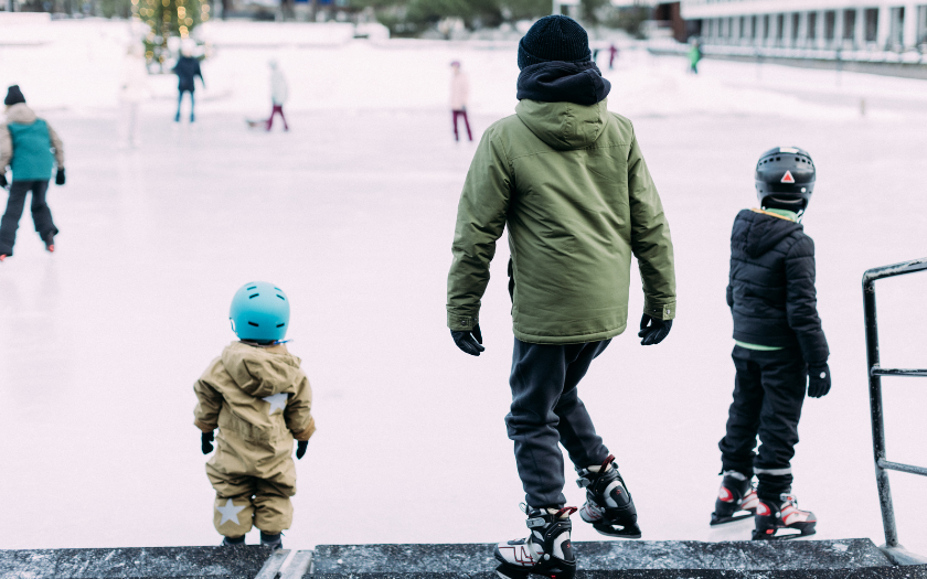 Children entering ice skating ring during winter