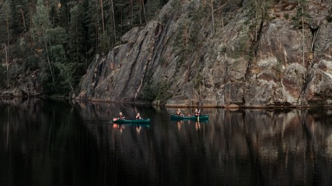 Group canoeing on lake in Nuuksio National Park