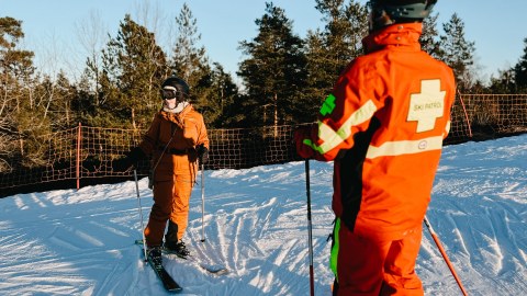 Woman skiing on slopes with instructor