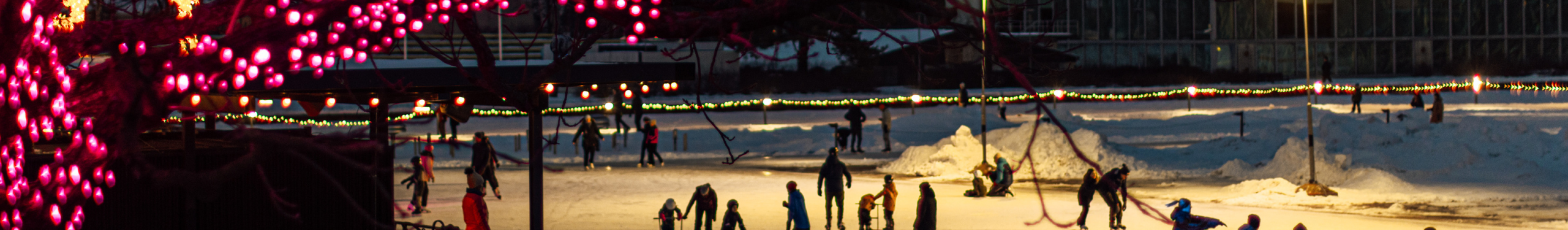 Evening lights of Tapiola Ice Garden with people ice skating