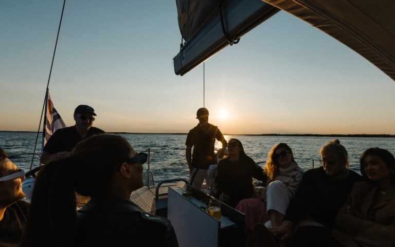 People on sailing boat during sunset