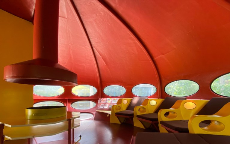 Image The contents of WeeGee's Futuro house with furniture in its red-yellow color scheme.
