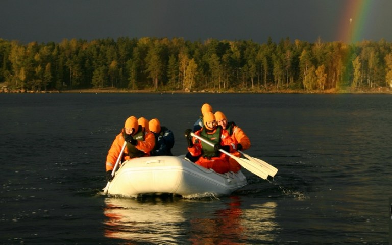 Six people rowing a rubber boat.
